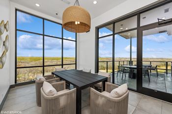 A modern dining room with a large table and chairs.